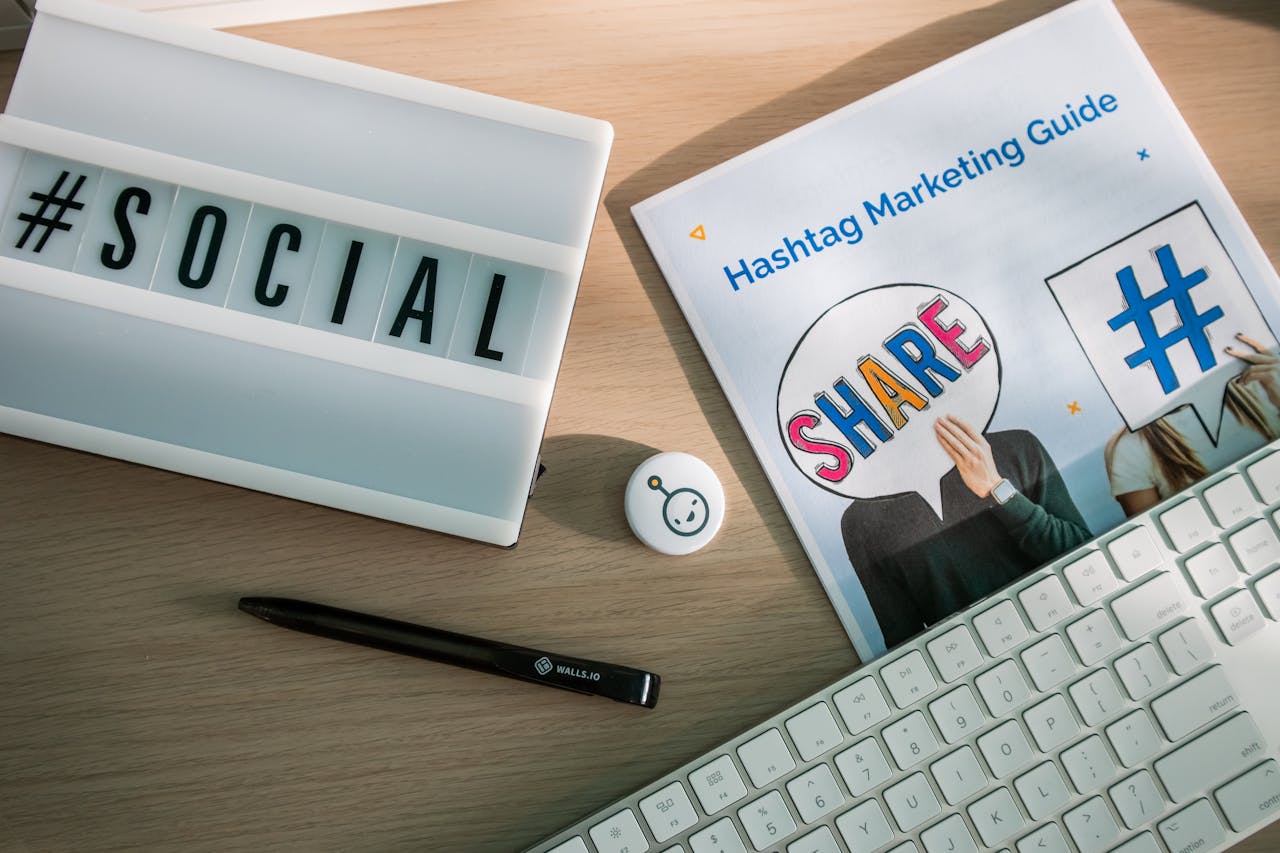 Services A desktop setup with social media marketing essentials including a keyboard, lightbox, and guide.