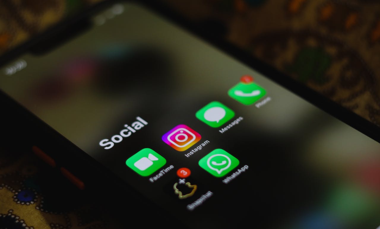 About A close-up shot of smartphone displaying social media apps icons on screen.